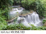 Erawan Waterfall, beautiful waterfall with sunlight rays in deep forest, Erawan National Park in Kanchanaburi, Thailand. Стоковое фото, агентство Ingram Publishing / Фотобанк Лори