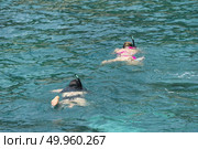 Phuket, THAILAND - JANUARY 4, 2017. A tourist wearing a bikini swim in the sea in Phuket. Редакционное фото, агентство Ingram Publishing / Фотобанк Лори
