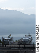 Nantou, Taiwan - November 02, 2016 : Tourist boats docking in peachful morning at Shuishe Pier, Sun Moon Lake, Taiwan. Редакционное фото, агентство Ingram Publishing / Фотобанк Лори