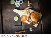 Top view of Rustic homemade hamburger and french fries with tomato sauce.. Top view of Rustic homemade hamburger and french fries with toma. Стоковое фото, агентство Ingram Publishing / Фотобанк Лори