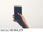 Close Up of a woman holding on mobile phone isolated on white ba. Close Up of a woman holding on mobile phone isolated on white background. Стоковое фото, агентство Ingram Publishing / Фотобанк Лори