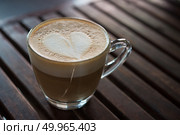 Close up of cappuccino cup with heart shaped milk pattern at caf. Close up of cappuccino cup with heart shaped milk pattern at cafe. a cup of coffee art. Стоковое фото, агентство Ingram Publishing / Фотобанк Лори