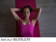 Middle Aged Athletic Woman Engaging in Self-Massage While Practicing Self-Care Indoors at Home. Стоковое фото, фотограф Aleksandr Golubev / Фотобанк Лори
