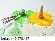 Colorful ice cream cones of different flavors. Melting scoops. Top view, copy space, steel metal background. Стоковое фото, агентство Ingram Publishing / Фотобанк Лори