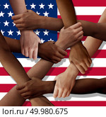 American diversity teamwork as a group of diverse United States people holding arms as a multiracial society and multicultural community joined and united as a strong together and togetherness concept. Стоковое фото, агентство Ingram Publishing / Фотобанк Лори
