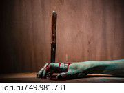 Closeup, Ghost woman or zombie hold knife for kill with blood violence in house of ruin, nightmare, horror of scary fear on hell is monster devil in halloween festival. Стоковое фото, агентство Ingram Publishing / Фотобанк Лори