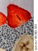 Superfoods breakfast with Chia seed pudding and berries and banana in a glass. Health concept, omega 3 product. Close up. chia seeds pudding with strawberries and bananas puree in glass jar, macro shot. Стоковое фото, агентство Ingram Publishing / Фотобанк Лори