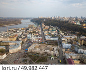 KIEV, UKRAINE - April 19, 2018: Cityscape of Kiev city. Guest Court , The former Greek Monastery and Ferris wheel on the Contract Square is central square in the historic Podil neighborhood of Kiev. Drone photo. KIEV, UKRAINE - April 19, 2018: Cityscape on Kontraktova Square in Kiev city on spring. Редакционное фото, агентство Ingram Publishing / Фотобанк Лори