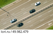 Aerial view of traffic on eight lane road through Kiev city, Ukraine. Asphalt road with white line on road. Aerial view on the of expressway across city road in the Kiev city. Редакционное фото, агентство Ingram Publishing / Фотобанк Лори
