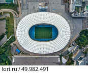 KIEV, UKRAINE - July 19, 2018. Panoramic view strrictly above the National Sports Complex Olimpiysky with surrounding area of Stadium in a summer time at sunset. Aerial view from drone. Top view.. KYIV, UKRAINE - July 19, 2018. Aerial viev from drone to the stadium -National Sports Complex NSC Olimpiysky with the area around the stadium. Редакционное фото, агентство Ingram Publishing / Фотобанк Лори