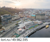 Panoramic view of the river station with walking ferries. Postal square, St. Andrew’s Church and a television tower in the distance at sunset on Podol in Kiev, Ukraine. Photo from the drone. Panoramic view of the river station and Postal square at the sunset in Podil in Kiev, Ukraine. Стоковое фото, агентство Ingram Publishing / Фотобанк Лори