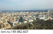 Aerial view city of Kiev on a sunny day. Park Pushkin and the Dnieper River in the distance. Photo from the drone. City of Kiev on a sunny day. Modern high-rise buildings and a park. Aerial photo from the drone. Стоковое фото, агентство Ingram Publishing / Фотобанк Лори