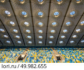 KIEV, UKRAINE - July 19, 2018. National Sports Complex Olimpiysky, panoramic view from drone on empty even rows tribunes of stadium and construction roof before soccer game in the summer time.. KYIV, UKRAINE - July 19, 2018. Elements of roof construction the stadium NSC Olimpiysky with empty tribunes in blue and yellow colors before the game. Редакционное фото, агентство Ingram Publishing / Фотобанк Лори