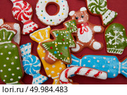Christmas Gingerbread Cookies on a red background.. Christmas cookies background. Стоковое фото, агентство Ingram Publishing / Фотобанк Лори