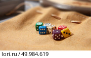 multicolored game dice for gambling, isolated on a brown background. Colorful dices on background. Стоковое фото, агентство Ingram Publishing / Фотобанк Лори