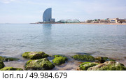Barceloneta Beach and Hotel Vela . Barcelona, Spain. Barceloneta Beach - one of the most popular in the city. Barceloneta Beach and Hotel Vela. Стоковое фото, агентство Ingram Publishing / Фотобанк Лори