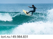 Surfer in action on the ocean waves on a cloudy day. Стоковое фото, агентство Ingram Publishing / Фотобанк Лори