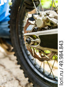 Off-road motorbike rear wheel close-up. Стоковое фото, агентство Ingram Publishing / Фотобанк Лори
