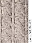 Handmade vintage beige knitting wool texture and background. Woolen knitting background. Стоковое фото, агентство Ingram Publishing / Фотобанк Лори