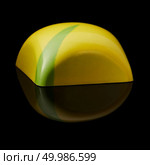 Sideways yellow chocolate candy on a black background. chocolate candy on black background. Стоковое фото, агентство Ingram Publishing / Фотобанк Лори