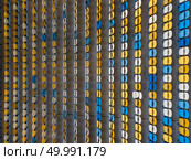 KIEV, UKRAINE - July 19, 2018. National Sports Complex Olimpiysky, aerial view from drone to a tribunes of stadium in a summer time before match. Panoramic view strictly above.. KYIV, UKRAINE - July 19, 2018. Aerial top view of empty blue and yellow seats on a tribunes of NSC Olimpiysky before the soccer game. Редакционное фото, агентство Ingram Publishing / Фотобанк Лори