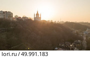 Skyline bird eye aerial view of the old part of the city Saint Andrew’s church under sunset sky in Kiev city, Ukraine. Sunset over Saint Andrew’s church in Kyiv, Ukraine. Стоковое фото, агентство Ingram Publishing / Фотобанк Лори