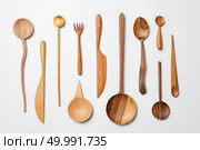 Wooden spoons, knives, forks on a white background. Wooden spoons, knives, forks o. Стоковое фото, агентство Ingram Publishing / Фотобанк Лори