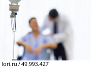 Set iv fluid intravenous drop saline drip in hospital room with patient and doctor in background. Стоковое фото, агентство Ingram Publishing / Фотобанк Лори