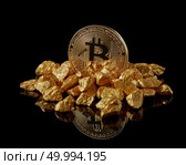 Golden bitcoin and gold lumps as world trends both isolated on black background with reflective surface. Digital virtual currency electronic money mining blockchain exchange innovation business. Studio shot of Bitcoin with gold nugget on a black reflective background .Digital virtual currency. Стоковое фото, агентство Ingram Publishing / Фотобанк Лори