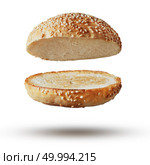 Roasted toasted burger top without fillings flying, levitating at white.. Burger bun empty isolated. Стоковое фото, агентство Ingram Publishing / Фотобанк Лори