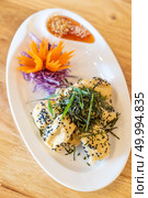 deep fried organic tofu topping with organic black sesame seaweed and leek. Thai Chinese organic street food and cuisine. Стоковое фото, агентство Ingram Publishing / Фотобанк Лори