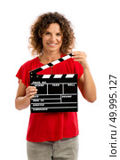Portrait of a smiling middle aged brunette holding a clapboard. Стоковое фото, агентство Ingram Publishing / Фотобанк Лори
