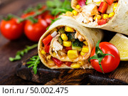 Burritos wraps with chicken meat and vegetables on wooden background. Стоковое фото, агентство Ingram Publishing / Фотобанк Лори
