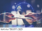 Man offering batch of hundred dollar bills. Hands close up. Venality, bribe, corruption concept. Hand giving money. Стоковое фото, агентство Ingram Publishing / Фотобанк Лори