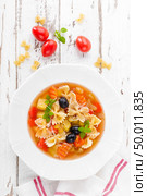 Minestrone, vegetarian soup with pasta and vegetables on white wooden rustic background. Traditional italian food. Top view. Стоковое фото, агентство Ingram Publishing / Фотобанк Лори
