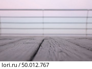 Empty delicate soft pink blured background of wooden deck with shallow depth of field. Can used for display or montage your products.. Wooden deck overlooking the sea sunrise with shallow depth of field. Стоковое фото, агентство Ingram Publishing / Фотобанк Лори