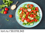 Healthy vegetarian vegetable salad of fresh lettuce, cucumber, sweet pepper and tomatoes. Vegan plant-based food. Flat Lay. Top view. Стоковое фото, агентство Ingram Publishing / Фотобанк Лори
