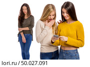 Teenagers making gossip from other girl. Стоковое фото, агентство Ingram Publishing / Фотобанк Лори