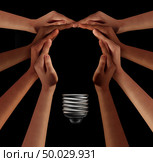 People together imagine and thinking teamwork as a diverse group coming together joining hands into the shape of an inspirational light bulb as a community support metaphor with 3D elements on black. Стоковое фото, агентство Ingram Publishing / Фотобанк Лори