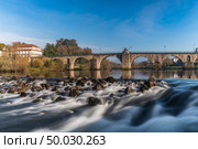 Bridge of Ponte da Barca, ancient portuguese village, on Minho river, north of Portugal. Стоковое фото, агентство Ingram Publishing / Фотобанк Лори