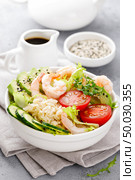 Hawaiian poke bowl with shrimps, rice and vegetables, healthy Buddha bowl with prawns, rice, avocado, cucumber, tomato and lettuce. Стоковое фото, агентство Ingram Publishing / Фотобанк Лори