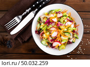 Healthy vegetarian vegetable salad with fresh raw radish, carrot, celery, lettuce, sesame and flax seeds. Vegan diet food. Стоковое фото, агентство Ingram Publishing / Фотобанк Лори