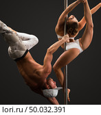 Studio photo of people dancing on pole in pair. Стоковое фото, фотограф Гурьянов Андрей / Фотобанк Лори