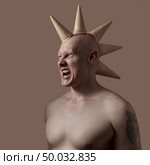 A bald man with a bare torso with ice cream cone on his head on a brown background . Sweet tooth concept or barbershop services. A man holds waffle cones on his head on a light brown background. Стоковое фото, агентство Ingram Publishing / Фотобанк Лори