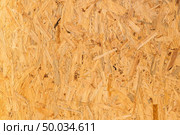 Pressed wooden panel background, seamless texture of oriented strand board - OSB wood. Стоковое фото, агентство Ingram Publishing / Фотобанк Лори