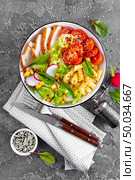 Grilled chicken meat with fresh vegetable salad of tomato, cucumber, radish, lettuce, chard leaves, corn and pasta. Healthy lunch menu. Top view. Стоковое фото, агентство Ingram Publishing / Фотобанк Лори
