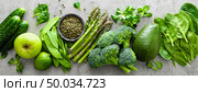 Healthy vegetarian food concept background, fresh green food selection for detox diet, raw broccoli, apple, cucumber, spinach, peas, asparagus, avocado, lime, corn salad and mung bean, view from above, flat lay, banner. Стоковое фото, агентство Ingram Publishing / Фотобанк Лори