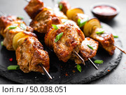 Grilled meat skewers, shish kebab on black background. Стоковое фото, агентство Ingram Publishing / Фотобанк Лори