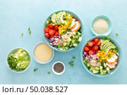 Lunch bowls with grilled cgicken meat, rice and fresh salad of avocado, cucumbers, corn, tomato and onion. Стоковое фото, агентство Ingram Publishing / Фотобанк Лори