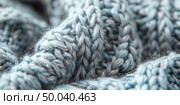 Close-up grey knitted pattern. yarn structure. Wool fibers create rich tactile surface with visible purl and knit stitches forming geometric rhythm. Стоковое AI-изображение, AI-художник Светлана Леуто / Фотобанк Лори